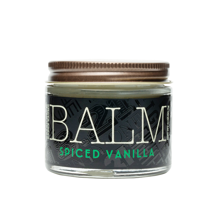 Jar of balm labeled 'Spiced Vanilla' on a white background