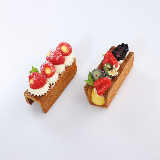Two small fruit tarts on a white background