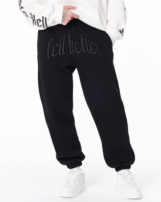 Martin Valen “Fell Better” men's black embroidered jogger, front close-up showing raised embroidery at the waistband with sweatshirt lifted