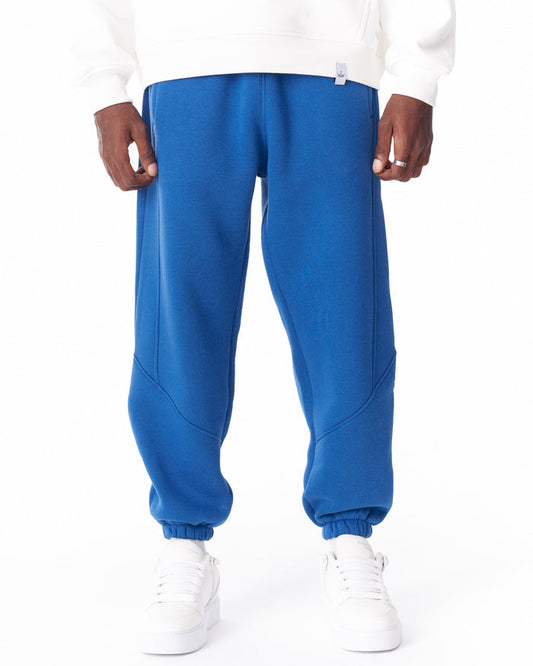 Martin Valen blue corded joggers, front mid-shot showing stitch details and elastic cuffs