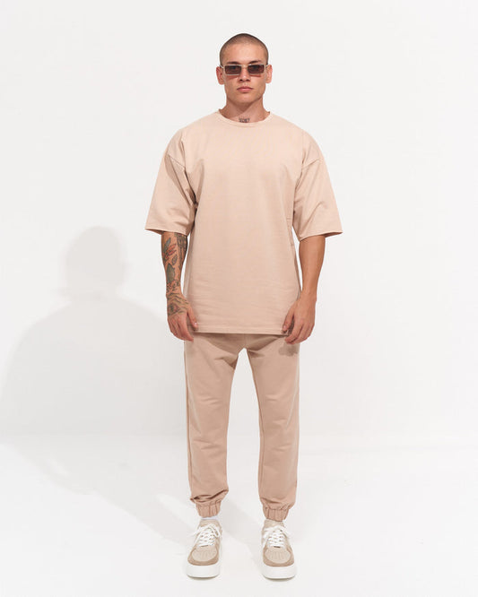 Martin Valen men's oversize tracksuit in cream, front mid-body view showing short sleeves and loose fit