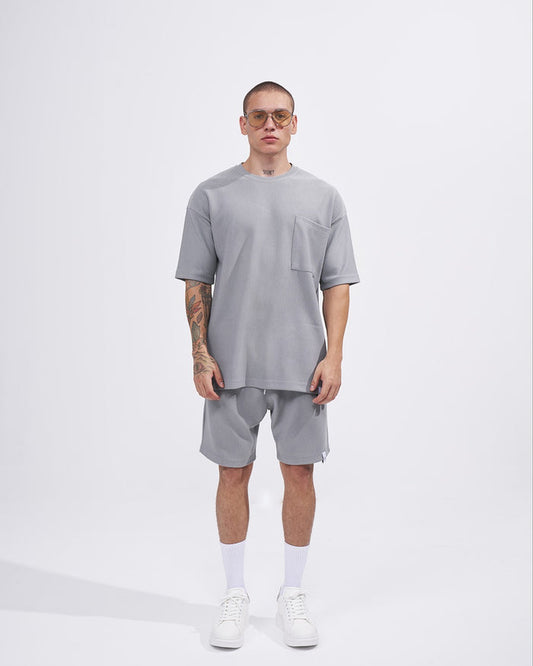 Martin Valen men's gray twill short tracksuit, front view on model showing chest pocket detail