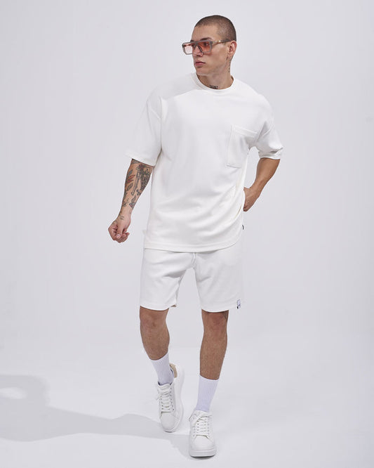 Martin Valen men's white twill short tracksuit, three-quarter walking view showing chest pocket detail
