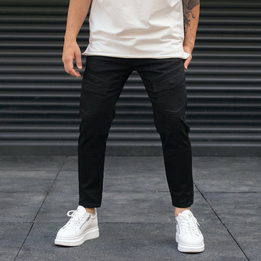 Martin Valen men's black utility jeans, front view on model showing side cross thigh pocket and cropped ankle