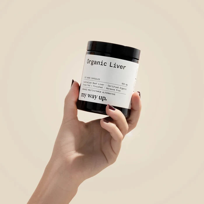 Hand holding a container labeled 'Organic Liver' with 'my way up.' on a beige background