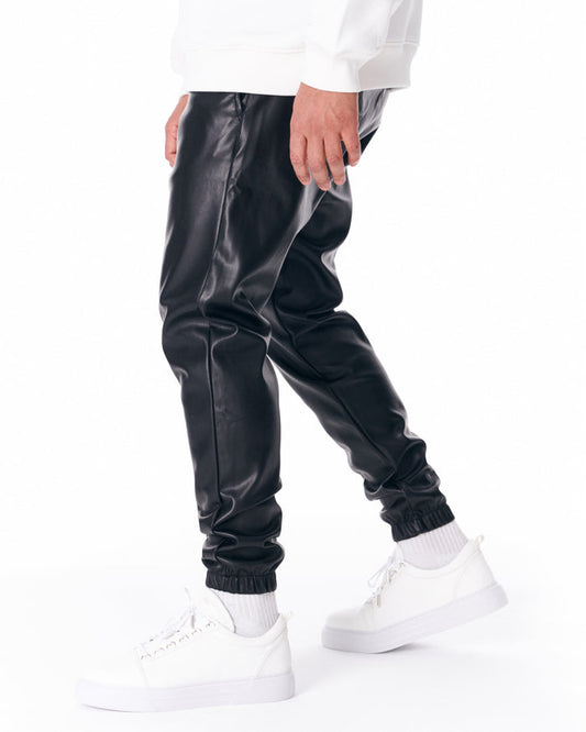 Martin Valen oversized leather jogger in black, side view showing elastic ankle and relaxed fit