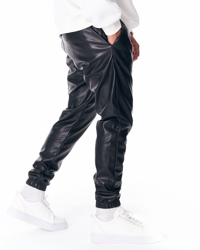 Martin Valen oversized leather jogger in black, close side detail showing pocket opening and seam