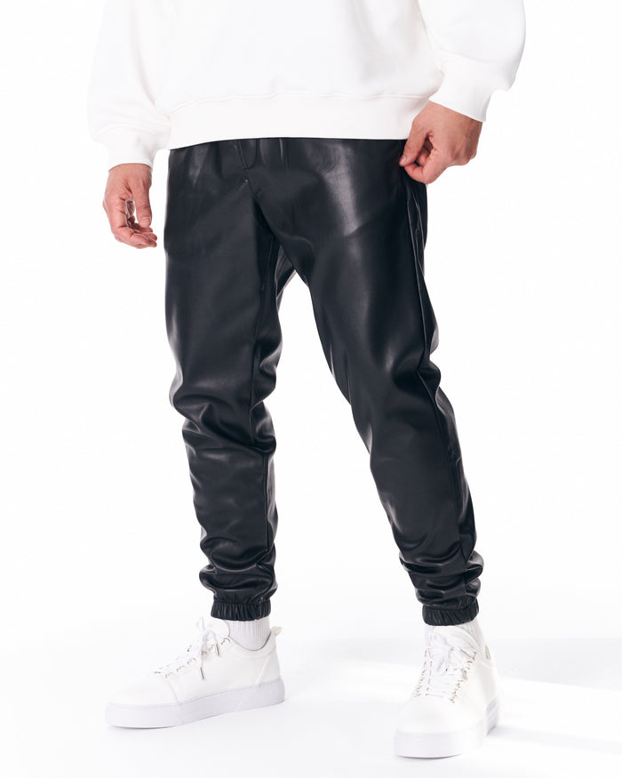 Martin Valen oversized leather jogger in black, mid shot of waistband with side seam and white sweatshirt overlapping