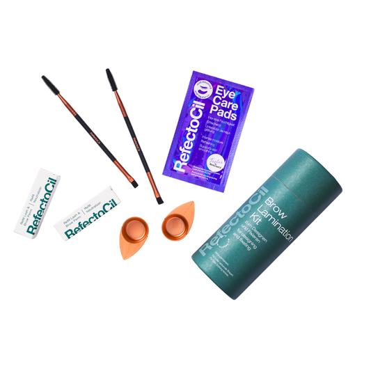 K029 Refectocil Professional Salon Eyebrow Lamination Kit | A RefectoCil brow lamination kit laid out on a white background, including a teal cylindrical lamination container, two brow pencils, two small orange applicator pads, two white tubes of RefectoCil eye care oil, and a purple packet of RefectoCil eye care pads.