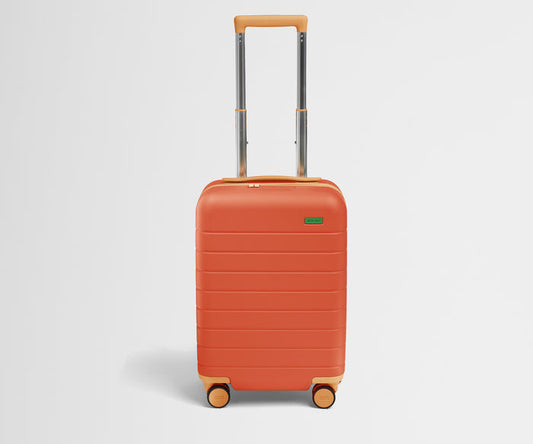 Front product view of The Kids Carry-On suitcase in Poppy Orange with raised handle