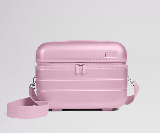 Pink travel case with a strap on a light gray background