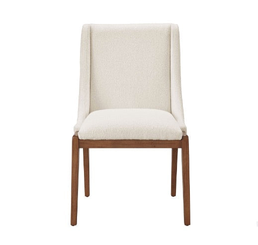 White upholstered dining chair with wooden legs on a white background.
