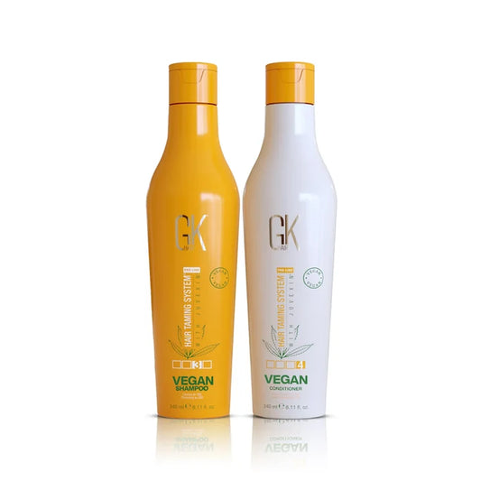 GK Hair Vegan Shampoo in an orange bottle and Vegan Conditioner in a white bottle, 240 ml each, on white
