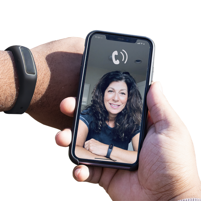 A person holding Virtual Peer BFRB Coaching with a woman's face on it.