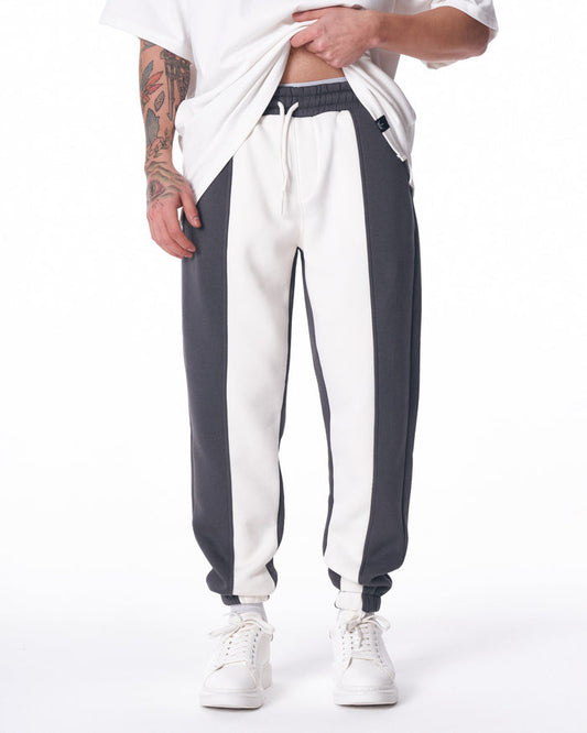 Martin Valen V'Reverse bicolor jogger in white and dark grey, front view showing elastic waistband and drawstring