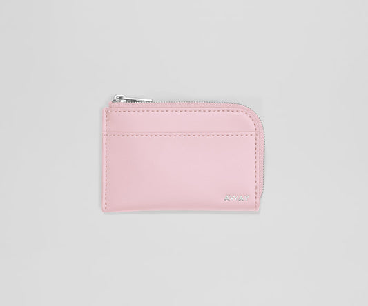 Pink wallet with a zipper on a light gray background